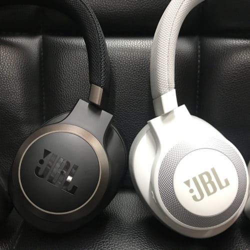 JBL Live 650BTNC earcup on left next to JBL E65BTNC in white on the right