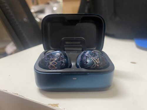 The Noble Osprey True Wireless Stereo Earphones within its aluminum charging case, powered off