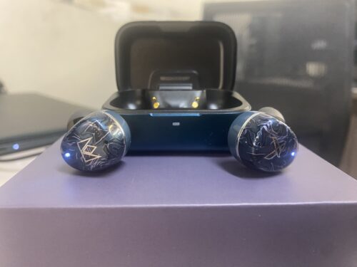 The Noble Osprey True Wireless Stereo Earphones outside of aluminum charging case, powered on