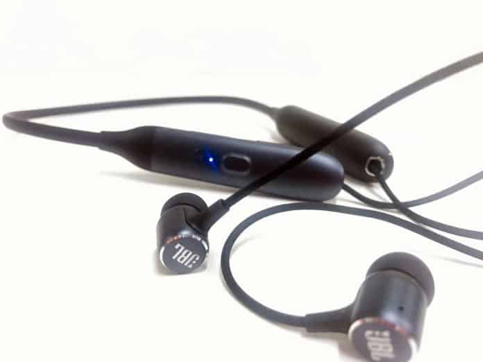 Close-up of JBL LIve 220BT earphones and neckband in the background